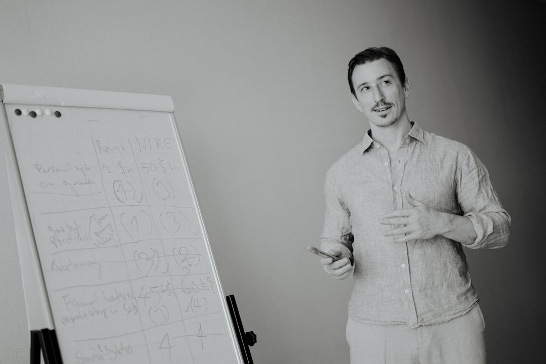 man-presenting-at-a-whiteboard-in-a-meeting-x8nnubypowe